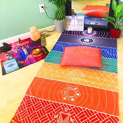 Colorful yoga mat with meditation accessories and plants