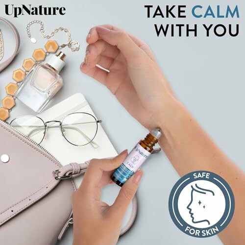 Person applying essential oil roll-on with accessories and text 'Take Calm With You'.